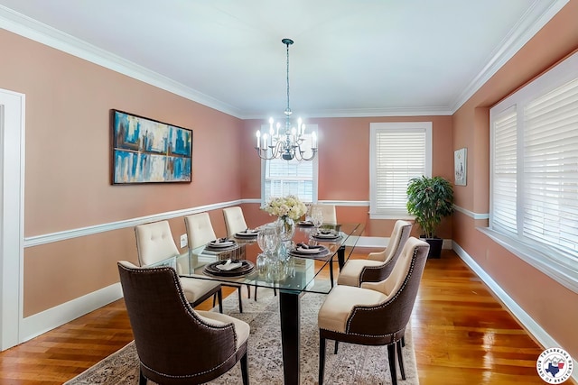 1203 Grand Ave, Texarkana, AR 71854 - dining area featuring an inviting chandelier, crown molding, baseboards, and wood finished floors