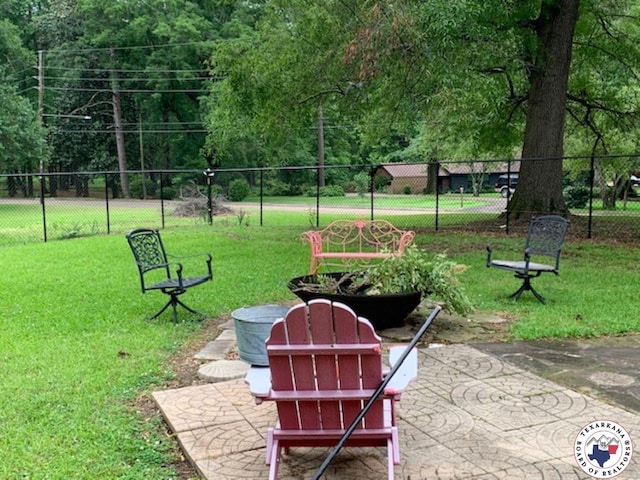 surrounding community featuring a patio, fence, and a lawn