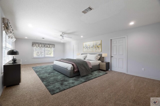 carpeted bedroom with recessed lighting, visible vents, a textured ceiling, and baseboards