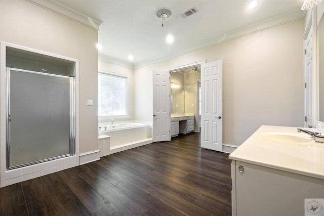 full bath with vanity, wood finished floors, a shower stall, and visible vents