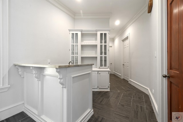 bar featuring ornamental molding and baseboards