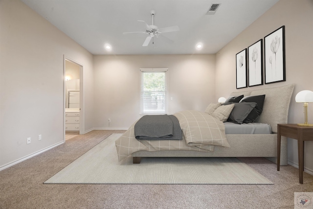 carpeted bedroom with ceiling fan and connected bathroom