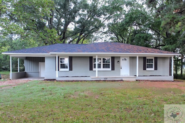 ranch-style house featuring a porch, a carport, and a front yard