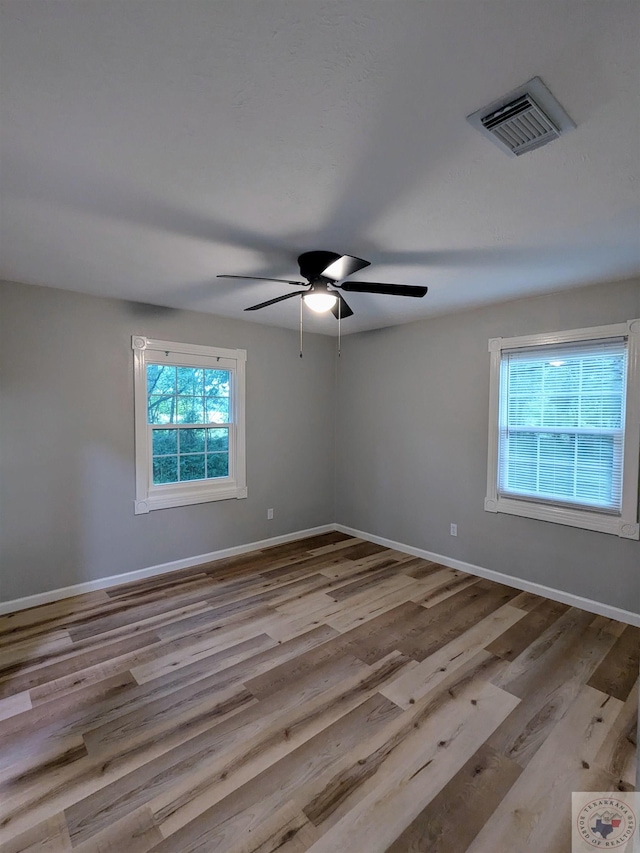 spare room with light hardwood / wood-style flooring and ceiling fan