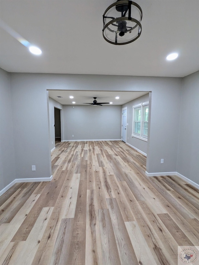 unfurnished living room featuring light hardwood / wood-style floors and ceiling fan