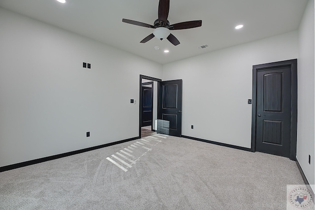 unfurnished bedroom featuring ceiling fan and light carpet