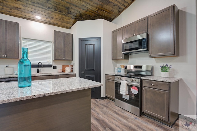 kitchen with dark brown cabinets, light stone counters, wood ceiling, lofted ceiling, and stainless steel appliances