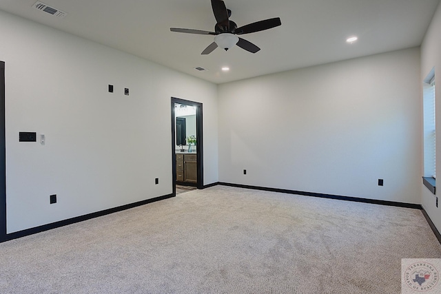 carpeted spare room with ceiling fan