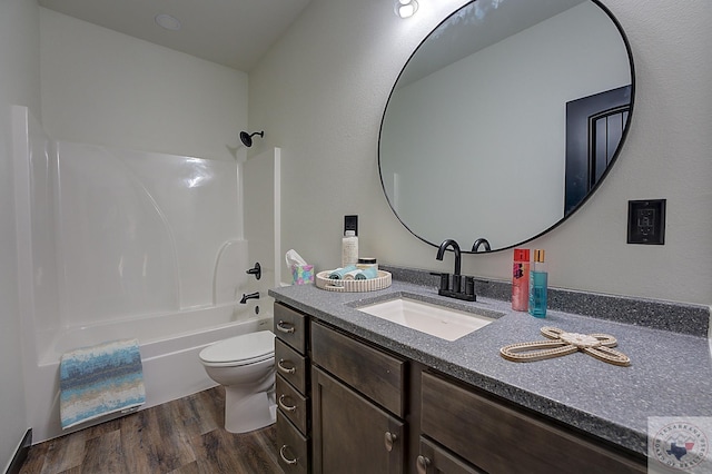 full bathroom with bathtub / shower combination, hardwood / wood-style floors, toilet, and vanity