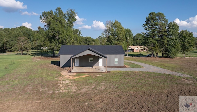 view of front of property with a patio area and a front lawn