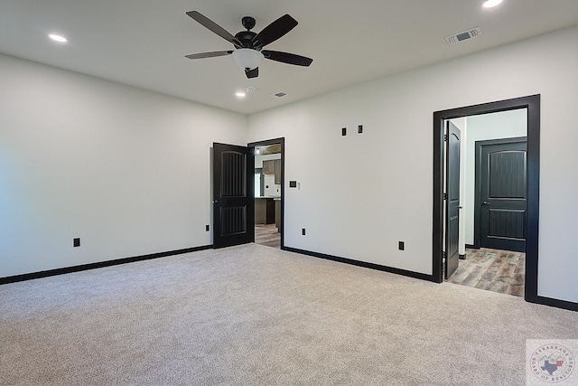 unfurnished bedroom featuring ceiling fan and light colored carpet