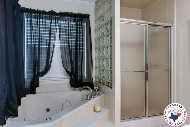 bathroom with a shower stall and a jetted tub
