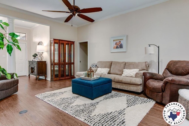 living room with wood finished floors, ceiling fan, and crown molding