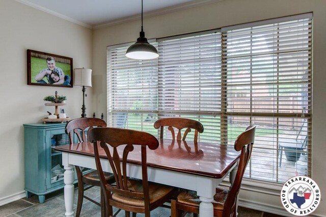 dining room with baseboards and crown molding