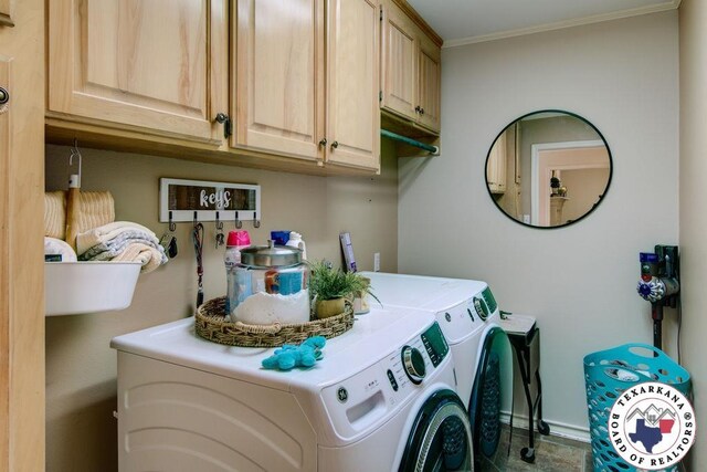 laundry area featuring cabinet space, crown molding, baseboards, and separate washer and dryer