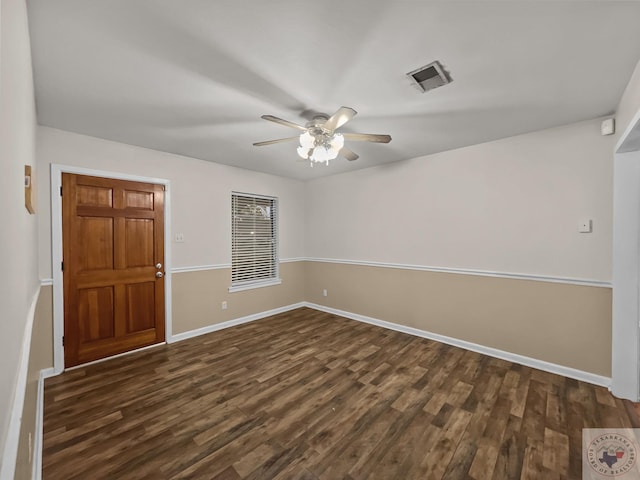 empty room with dark hardwood / wood-style floors and ceiling fan