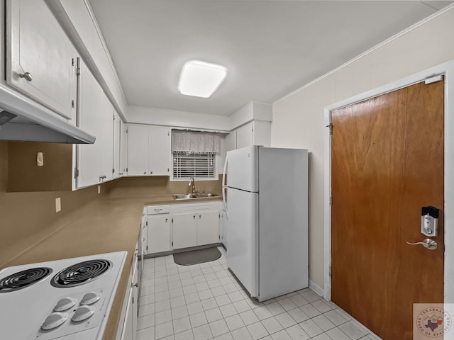 kitchen with cooktop, white cabinets, white refrigerator, and sink