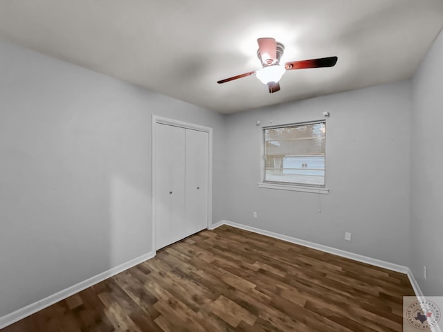 unfurnished bedroom featuring a closet, ceiling fan, and dark hardwood / wood-style flooring