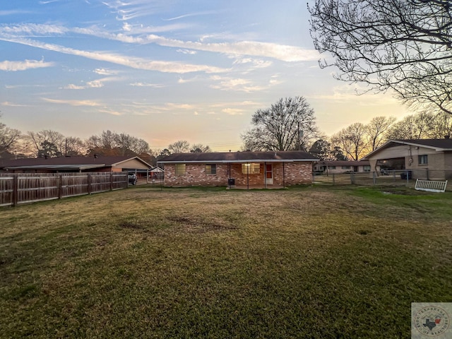 view of yard at dusk