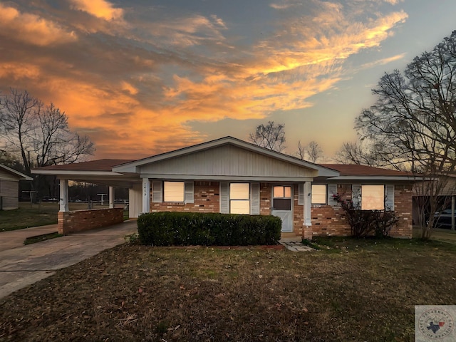 ranch-style house with a yard and a carport