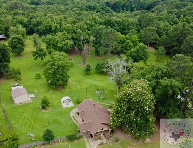 drone / aerial view featuring a view of trees