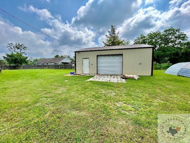 detached garage featuring fence