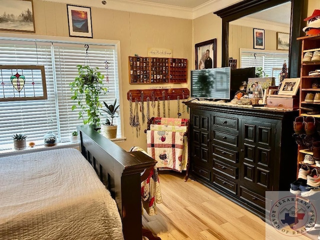 bedroom featuring ornamental molding and wood finished floors