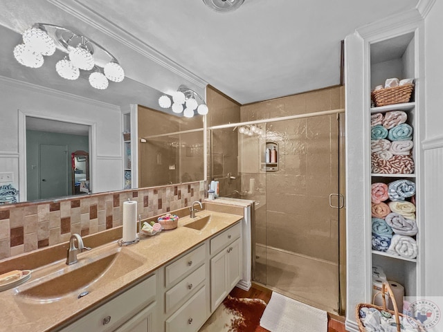 bathroom featuring vanity, ornamental molding, decorative backsplash, and an enclosed shower