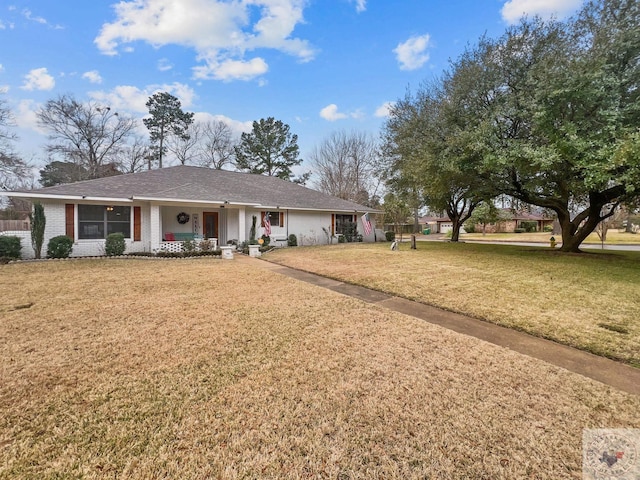 ranch-style home featuring a front yard and a porch