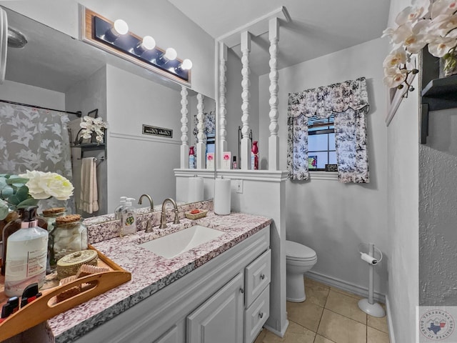 bathroom with curtained shower, tile patterned floors, toilet, and vanity