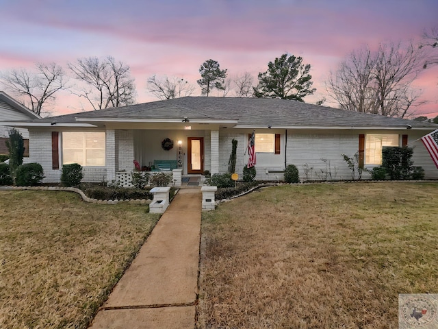 single story home with a yard