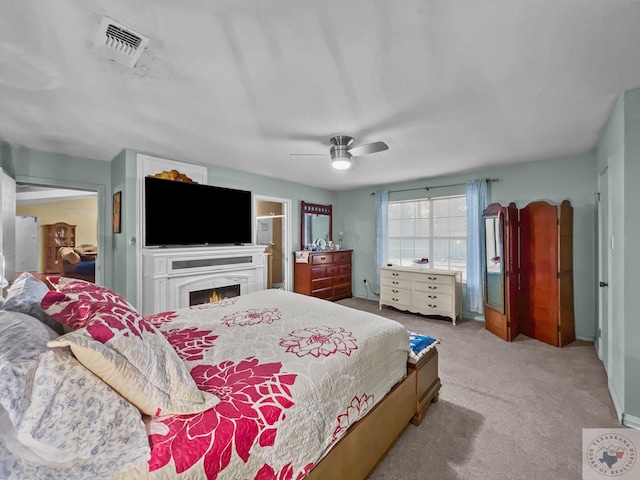 bedroom featuring light colored carpet and ceiling fan