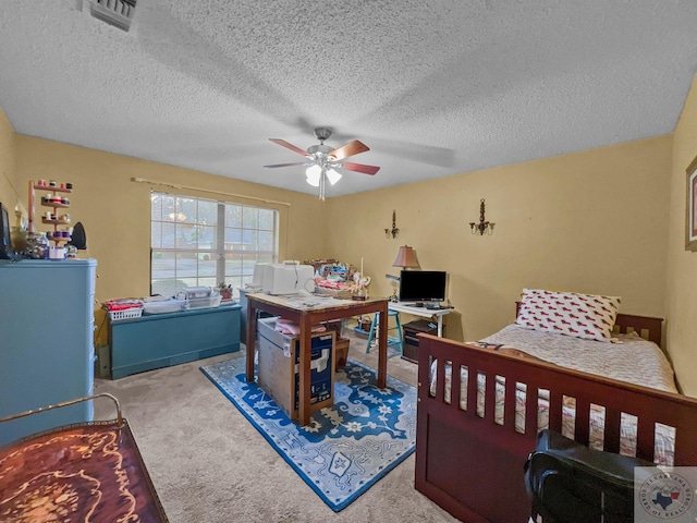 carpeted bedroom featuring a textured ceiling and ceiling fan