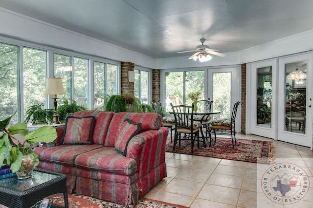 sunroom featuring ceiling fan