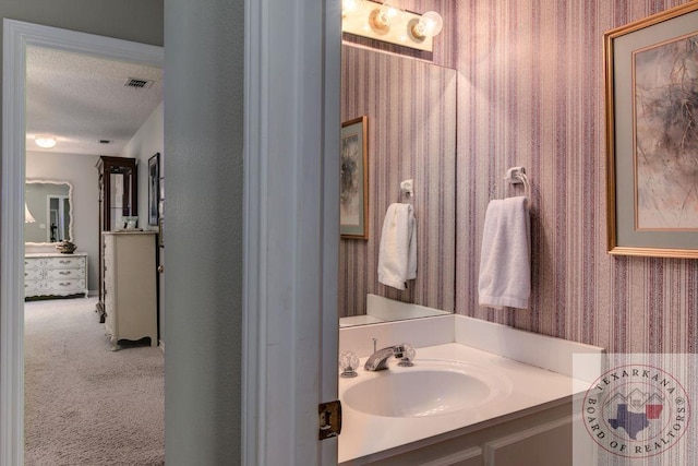 bathroom with vanity and a textured ceiling