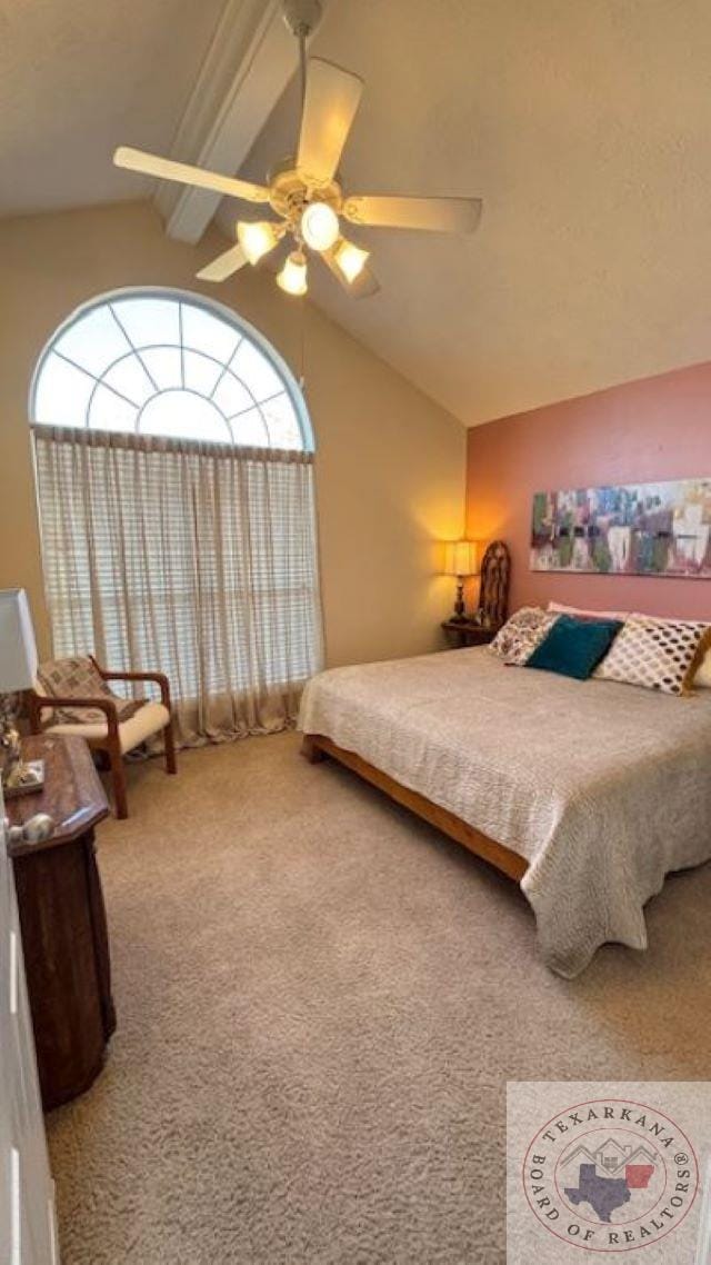 carpeted bedroom with ceiling fan and lofted ceiling with beams