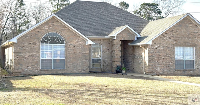 view of property featuring a front lawn