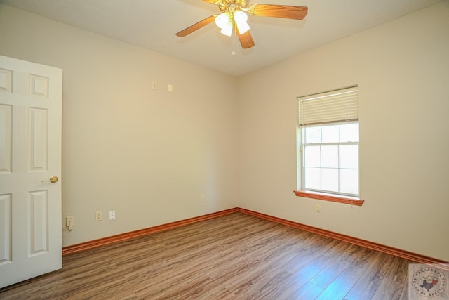 empty room with ceiling fan and hardwood / wood-style floors