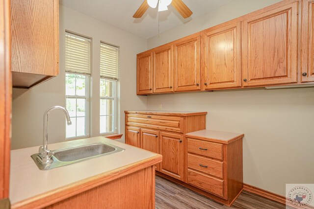 676 Akin Rd, Texarkana, TX 75503 - kitchen featuring sink, light wood-type flooring, and ceiling fan