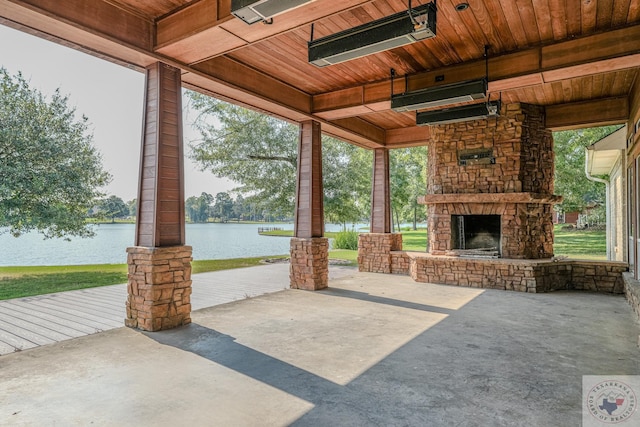 676 Akin Rd, Texarkana, TX 75503 - view of patio featuring an outdoor stone fireplace and a water view