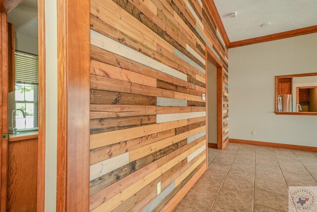 676 Akin Rd, Texarkana, TX 75503 - hall featuring sink, wooden walls, light tile patterned floors, and crown molding