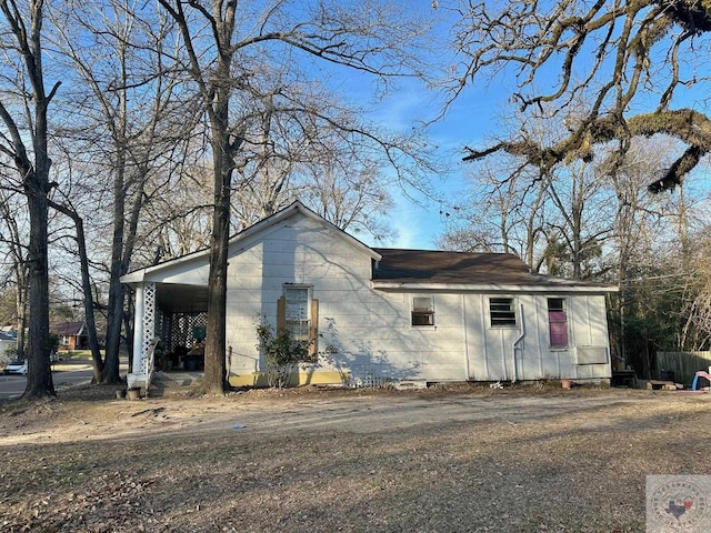 view of side of property featuring a carport