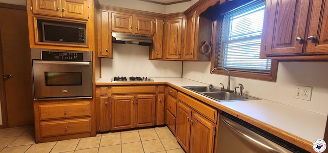 3507 Belmont Ave, Texarkana, AR 71854 - kitchen featuring appliances with stainless steel finishes, under cabinet range hood, light countertops, light tile patterned floors, and brown cabinetry