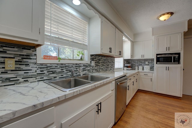 kitchen featuring sink, white cabinetry, appliances with stainless steel finishes, and tasteful backsplash