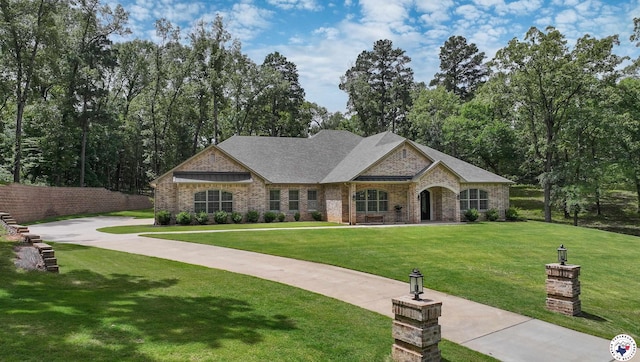 8907 River Ridge Drive, Texarkana, TX 75503 - french country home with a front lawn and brick siding