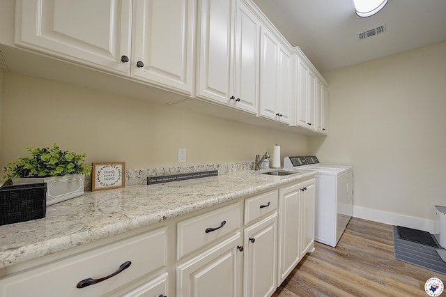 8907 River Ridge Drive, Texarkana, TX 75503 - clothes washing area with separate washer and dryer, cabinet space, light wood-style flooring, and baseboards