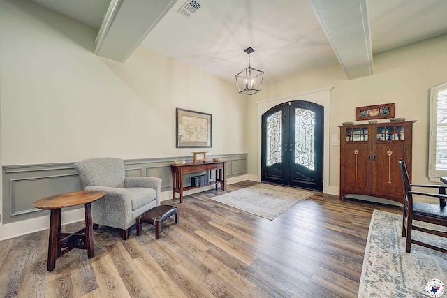 8907 River Ridge Drive, Texarkana, TX 75503 - entryway with french doors, wood finished floors, beam ceiling, a chandelier, and wainscoting