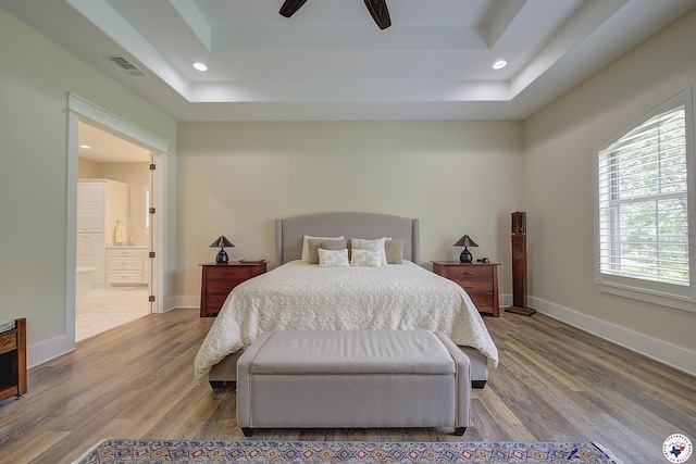 8907 River Ridge Drive, Texarkana, TX 75503 - bedroom featuring a tray ceiling, wood finished floors, baseboards, connected bathroom, and recessed lighting