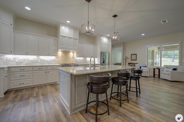 8907 River Ridge Drive, Texarkana, TX 75503 - kitchen featuring a sink, high end refrigerator, white cabinetry, and recessed lighting