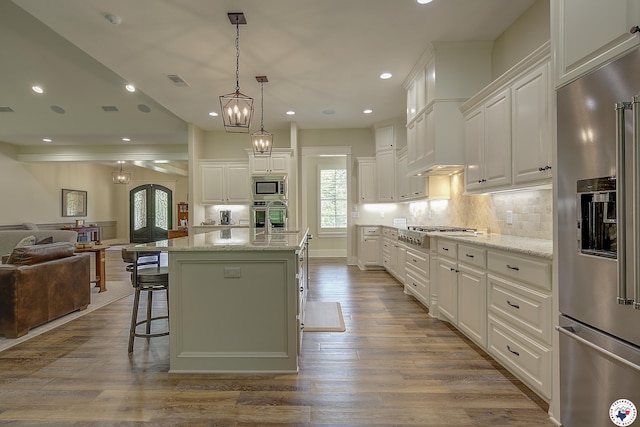 8907 River Ridge Drive, Texarkana, TX 75503 - kitchen featuring appliances with stainless steel finishes, open floor plan, recessed lighting, white cabinetry, and light stone counters